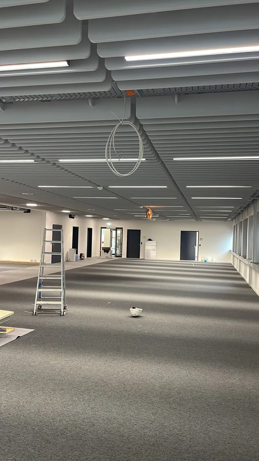 White acoustic baffle ceiling in open space — 1